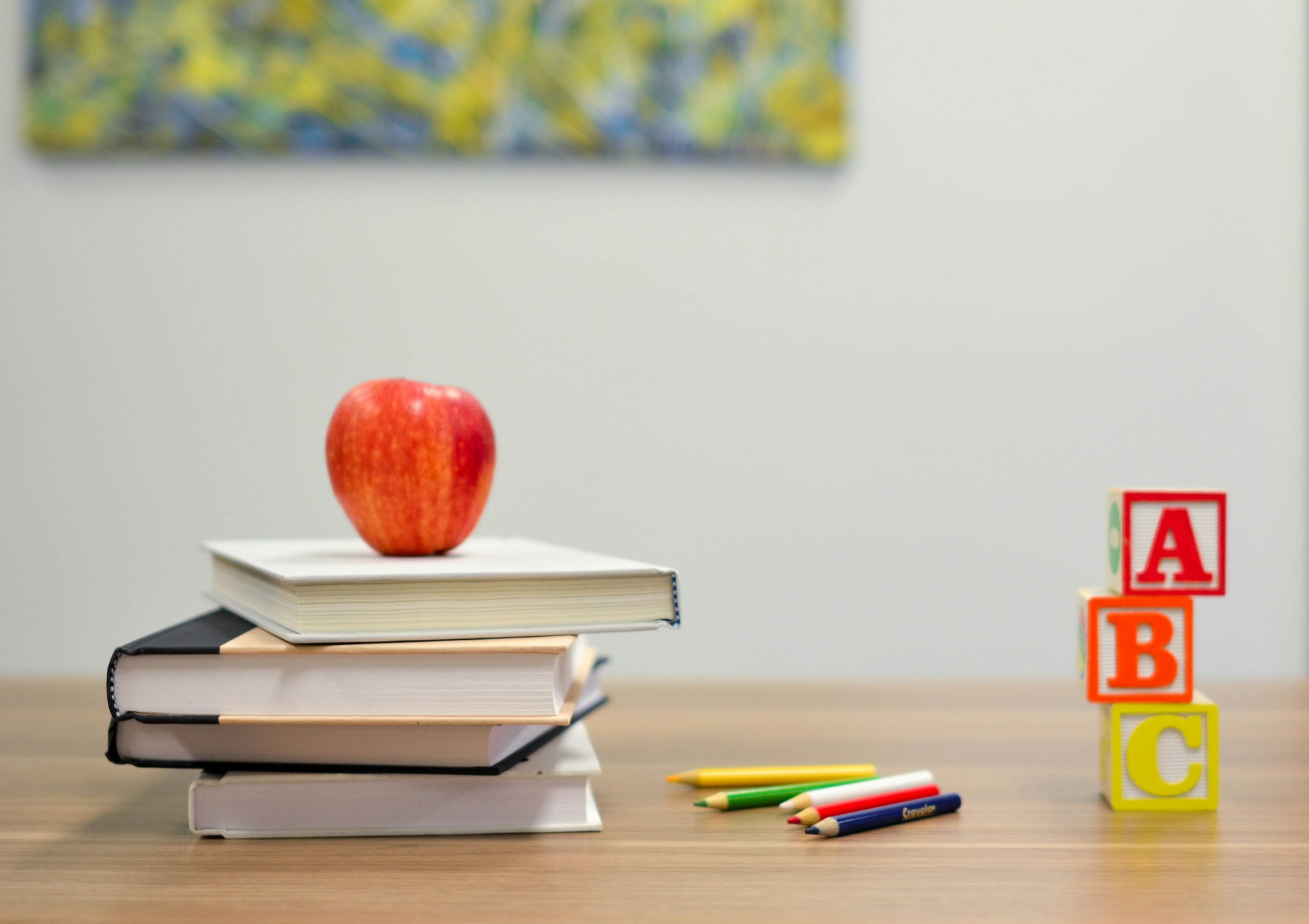 A stack of language books in soft natural light, the visual of fluency across many tongues.