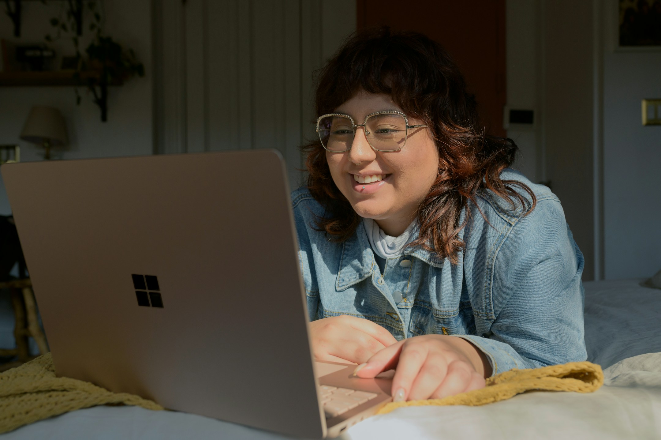 A woman with glasses focused on her laptop in a quiet professional setting, the kind of partner who used to take every intake call.