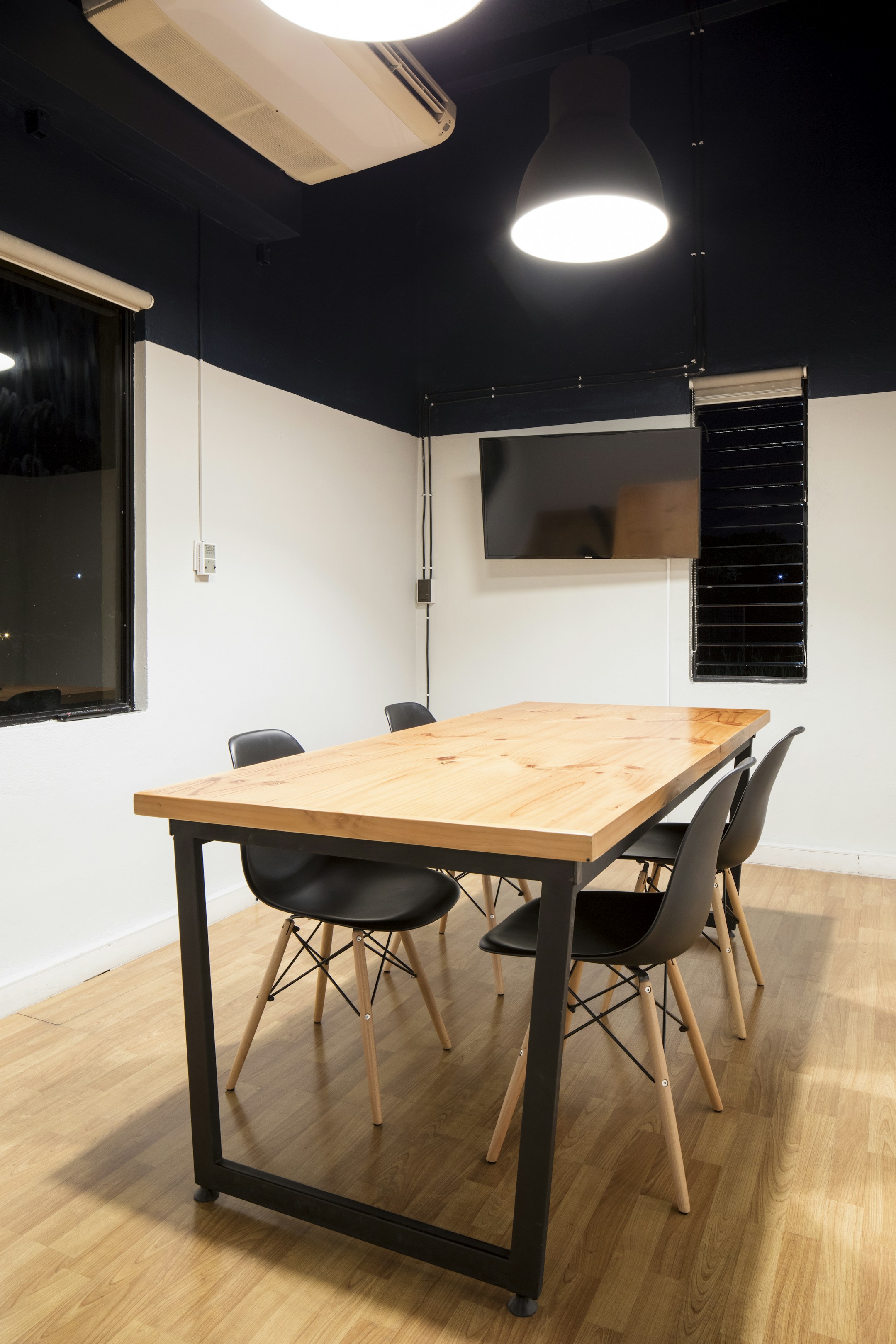 A wooden meeting table at a quiet office, the institutional setting where customer history is held.