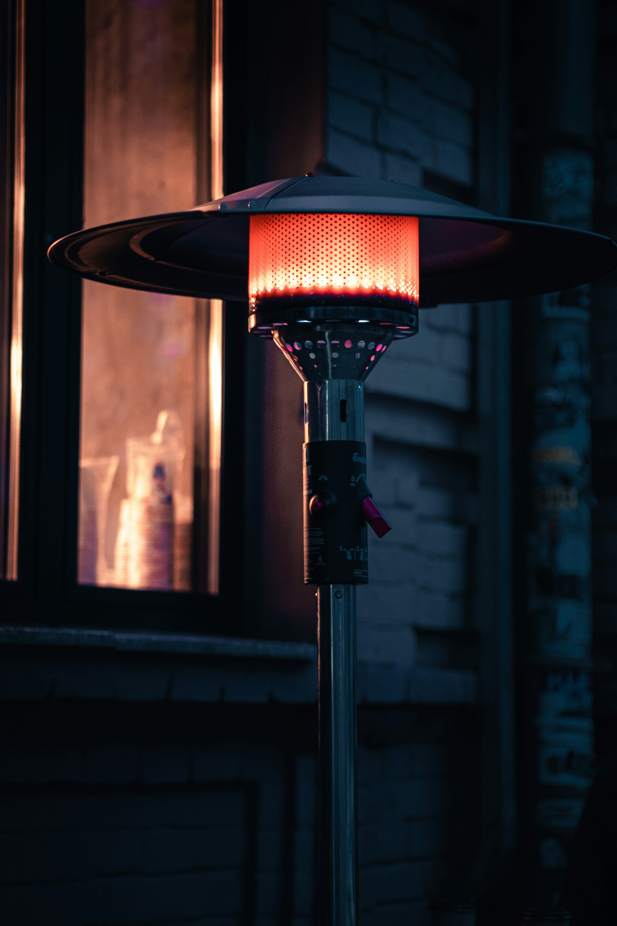 An outdoor lamp glowing at night beside a path, the metaphor of a light always on without anyone needing to flip a switch.