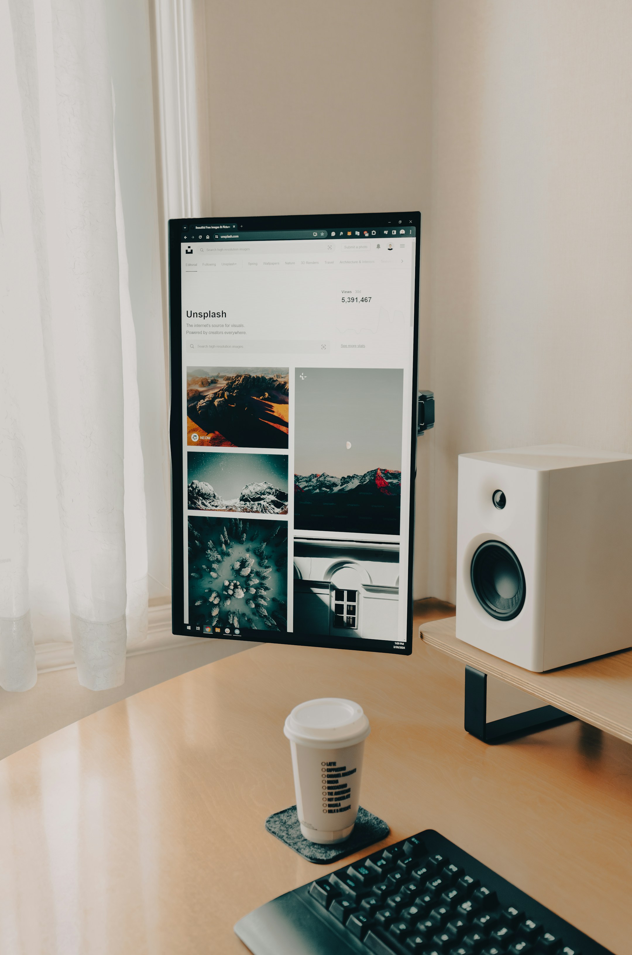 A coffee mug beside a desktop monitor in a quiet workspace, the visual of focused research with a clean output coming.