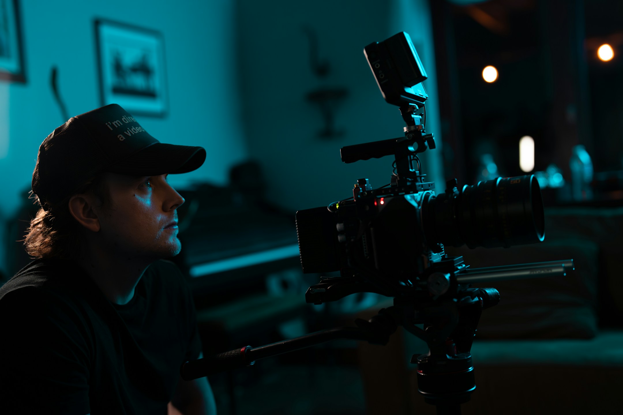 A vlogger in a living room behind their camera, the kind of solo professional whose web leads matter most.