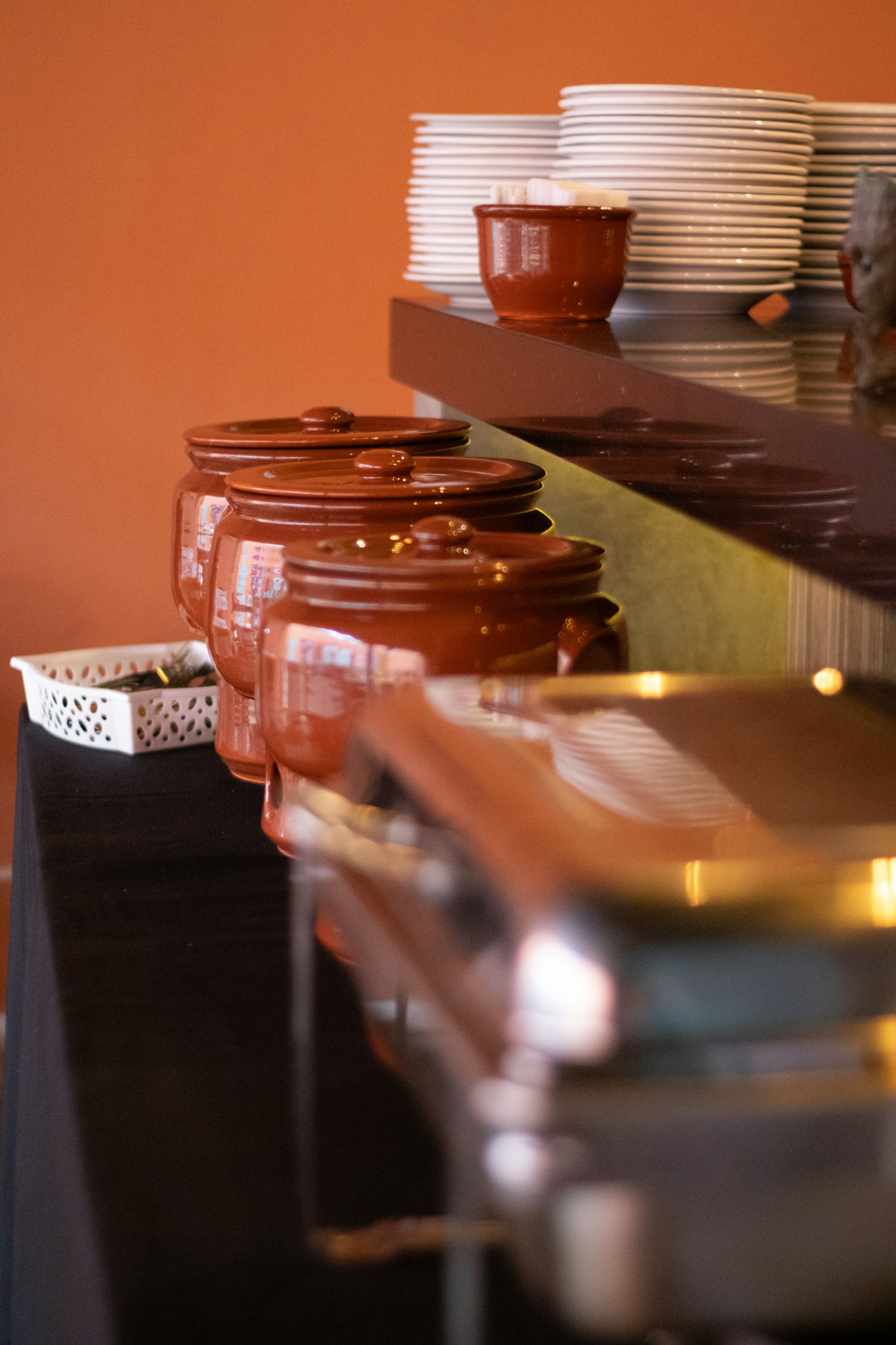 A still life of small bowls and dishes on a wooden table, soft and lived-in, the home where messaging-first agents live.