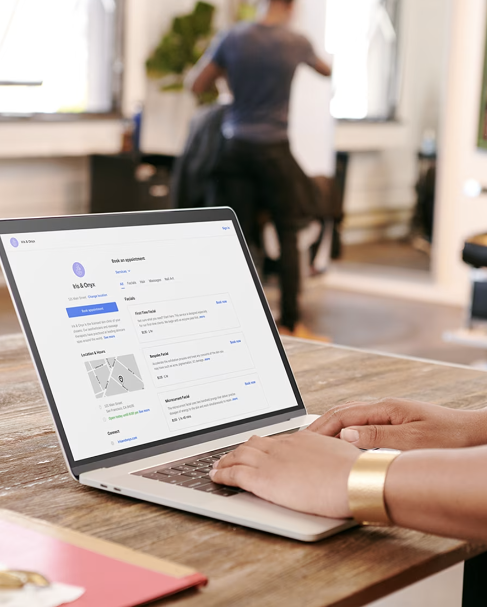 A barber on a laptop reviewing the booking app -- the SMB owners a Sales Partner sells to.