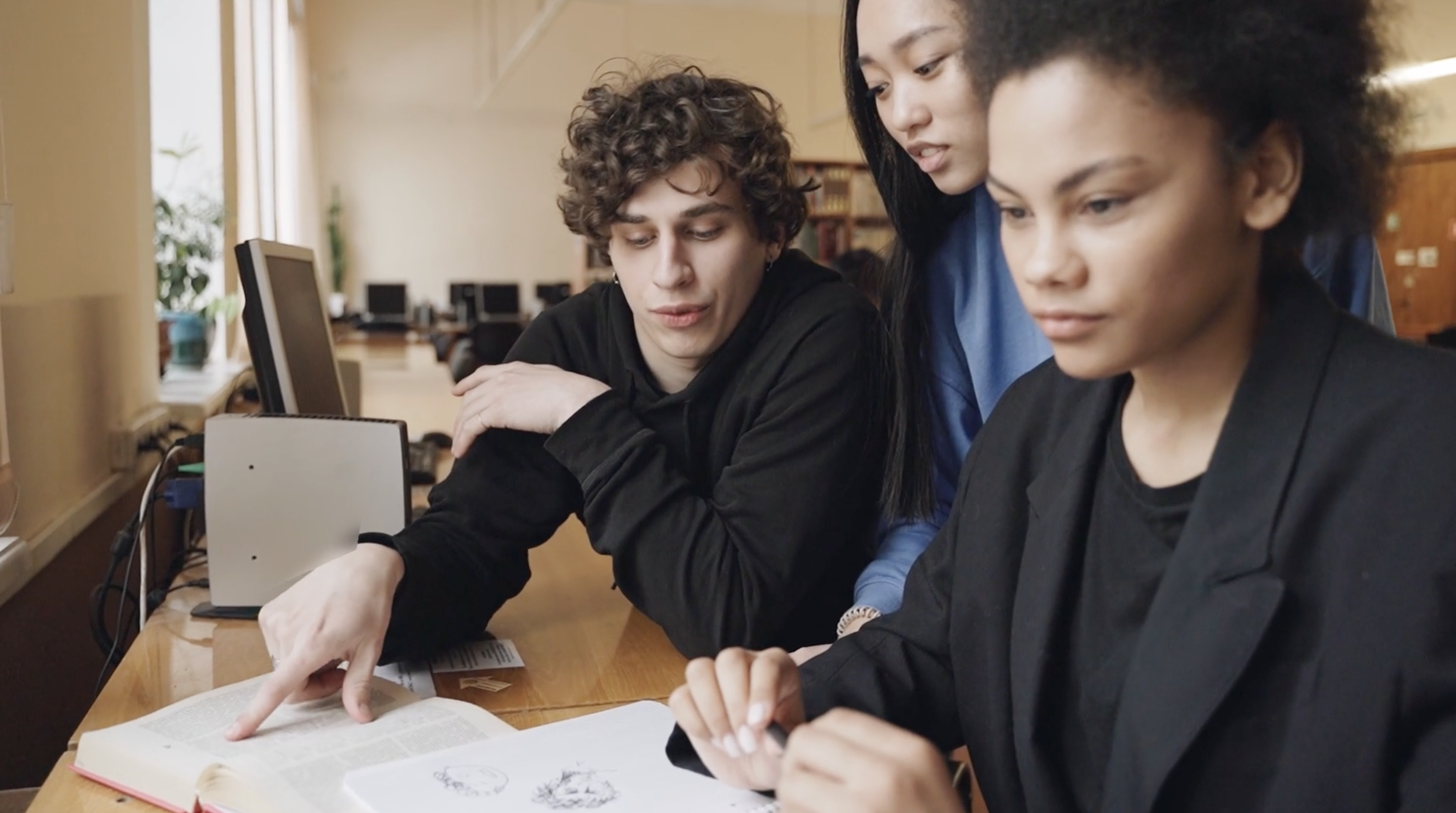 A group of young professionals working together on a project -- the Sales Partner archetype: ambitious, collaborative, building their own thing.